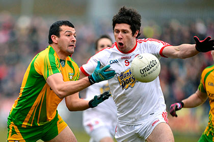 Tyrone's Sean Cavannagh and Donegal's Frank McGlynn. INPHO