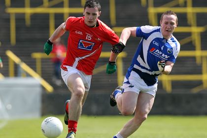 Louth's Derek Maguire and Peter O'Leary of Laois race for possession.<br />©INPHO/Colm O'Neill.